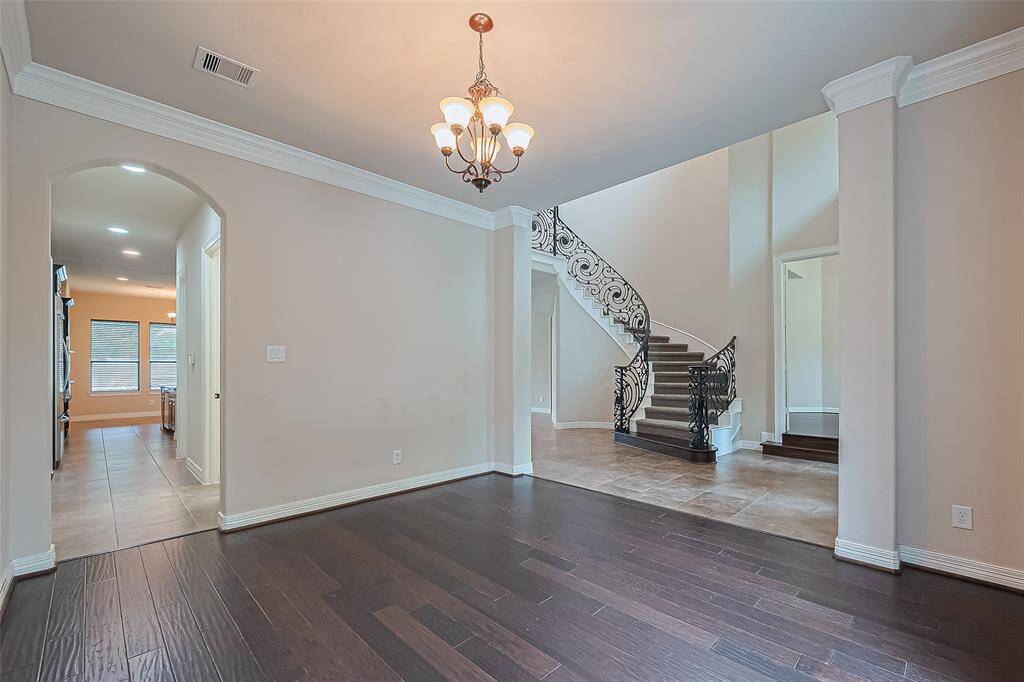 Through the curved archway is the walk-in pantry and access to the 3 car attached garage.