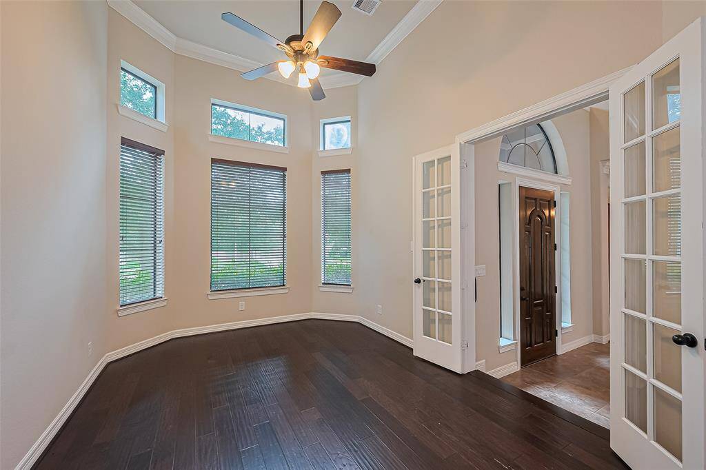 Enter through the French doors to this first floor 10x16 room which is perfect to use as an office or study. Here you will also find a raised,14 foot ceiling. Floors are a 4" distressed oak and solid oak treads. The windows are a bay style.