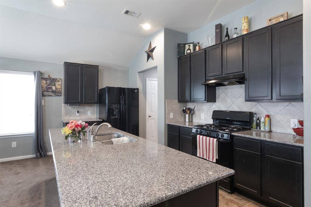 42" Hardwood Kitchen Cabinets & all black appliances.