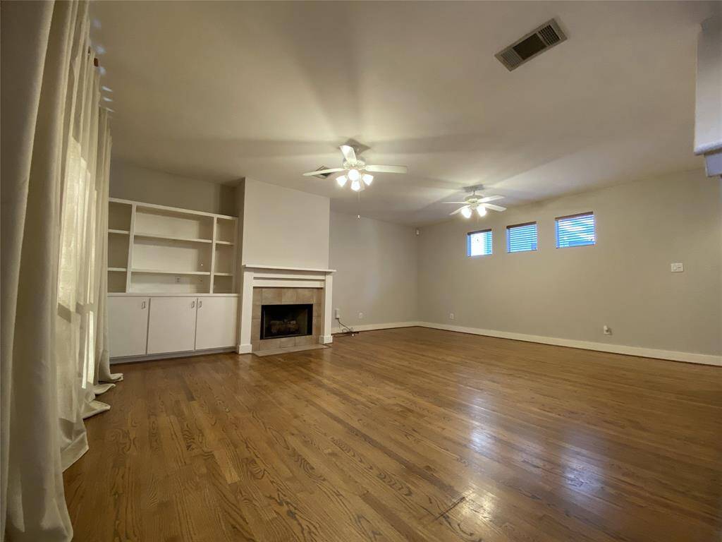 On the 2nd floor, the spacious living/dining space offers beautiful hardwood flooring, built-in storage and a gas log fireplace. The light fixtures in the ceiling fans are dimmer controlled.