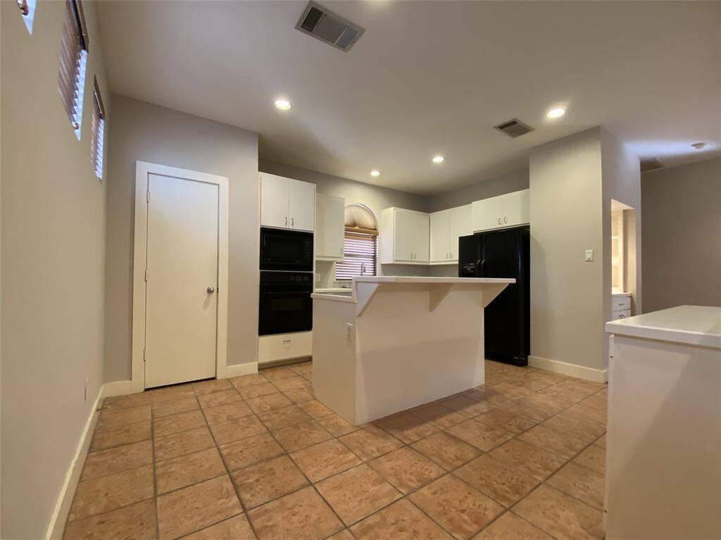 The kitchen offers a island with breakfast bar & dimmer controlled recessed lighting.
