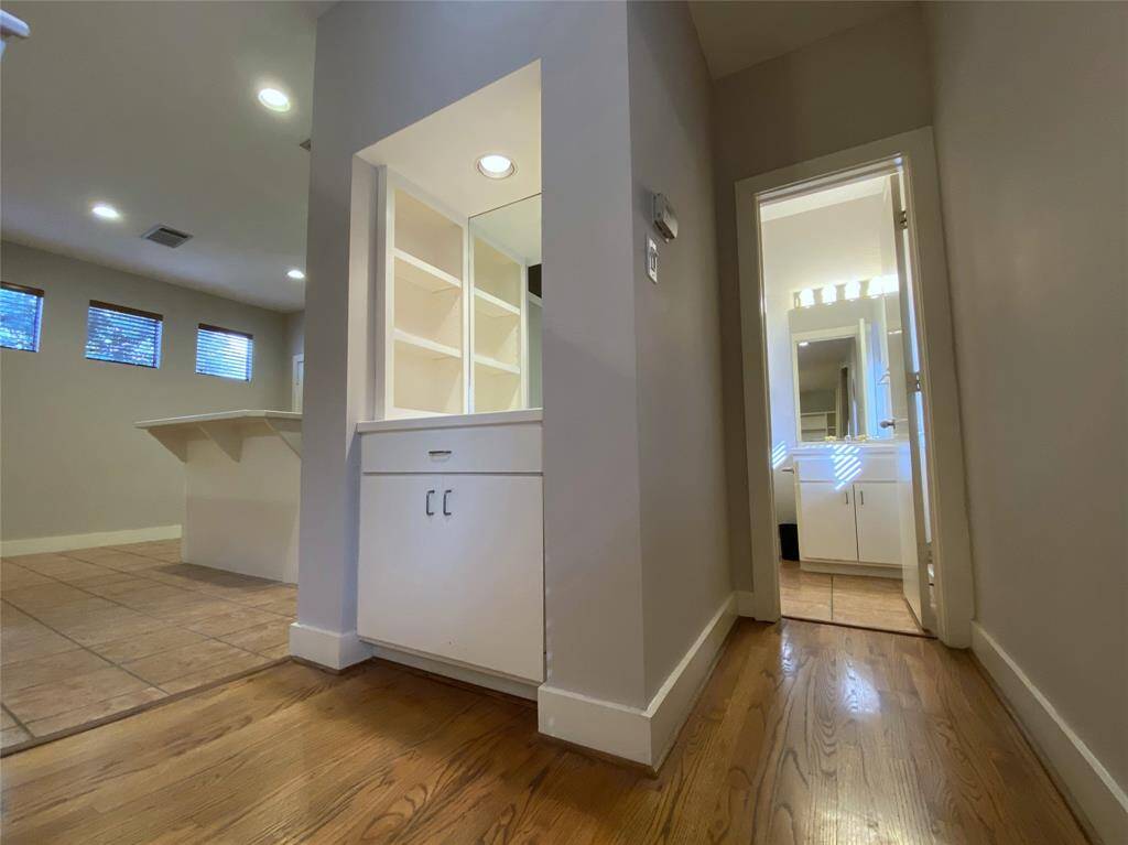 Between the kitchen and convenient 1/2 bath is a dry bar with a dimmer controlled recessed light fixture.