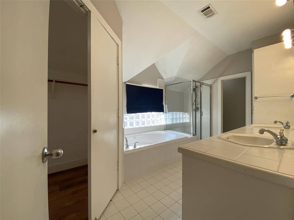 In the primary bathroom, there is a walk-in closet.