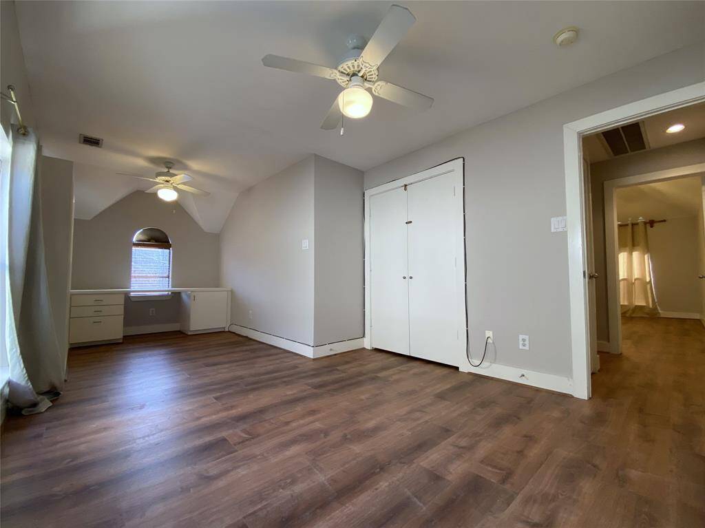 On the 3rd floor, the secondary bedroom with built-in desk & two ceiling fans with dimmer controlled light fixtures.