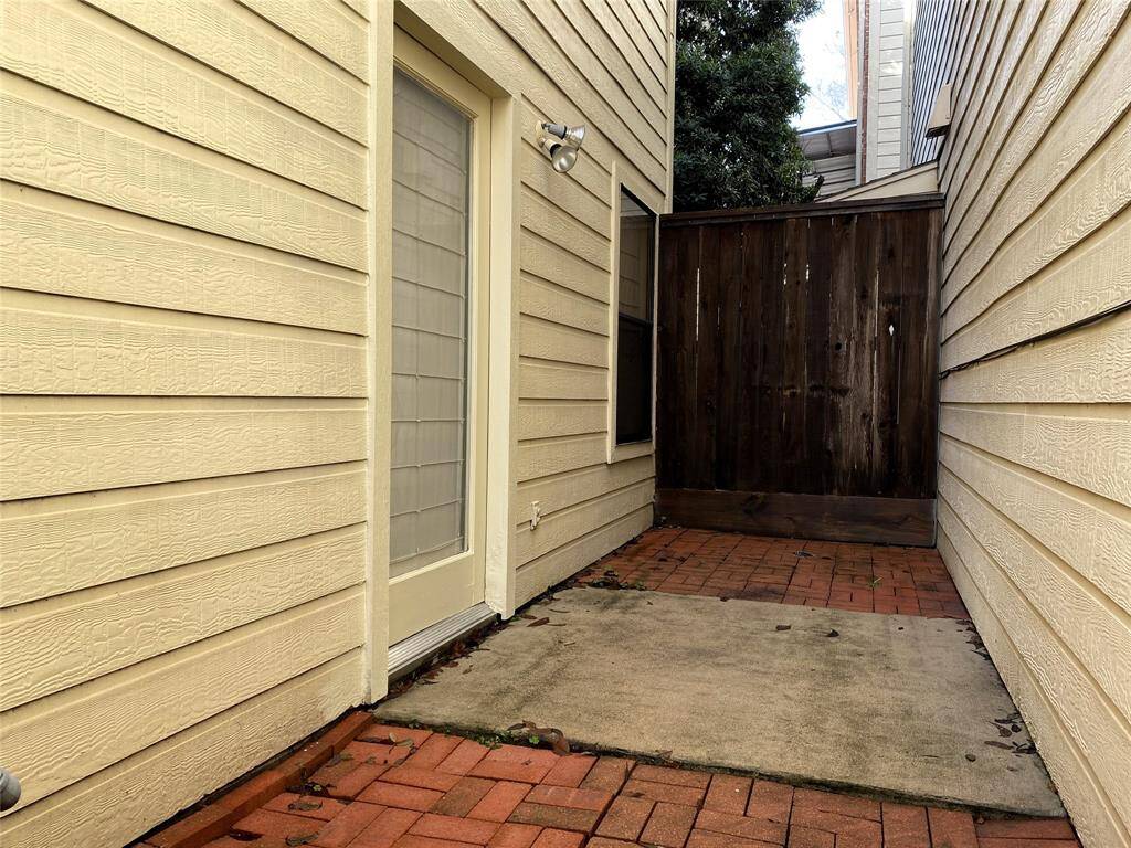 The patio is a mix of concrete and brick.