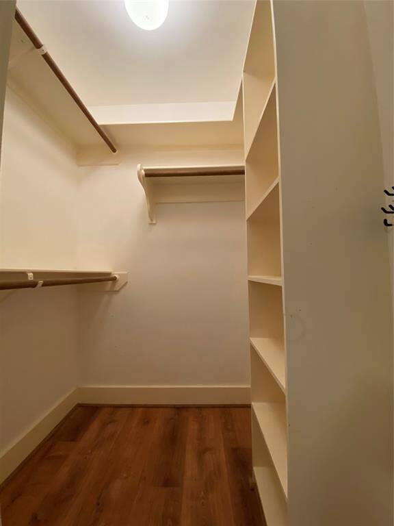 The step-in closet with built-in shelving and ample hanging.