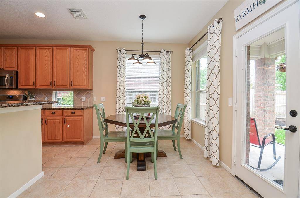 Large breakfast area with windows bringing in natural light.