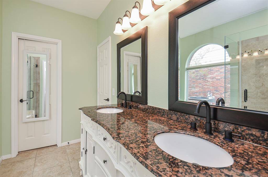 Double sinks.  New faucets in 2025.  This luxury bathroom makes getting ready fun.