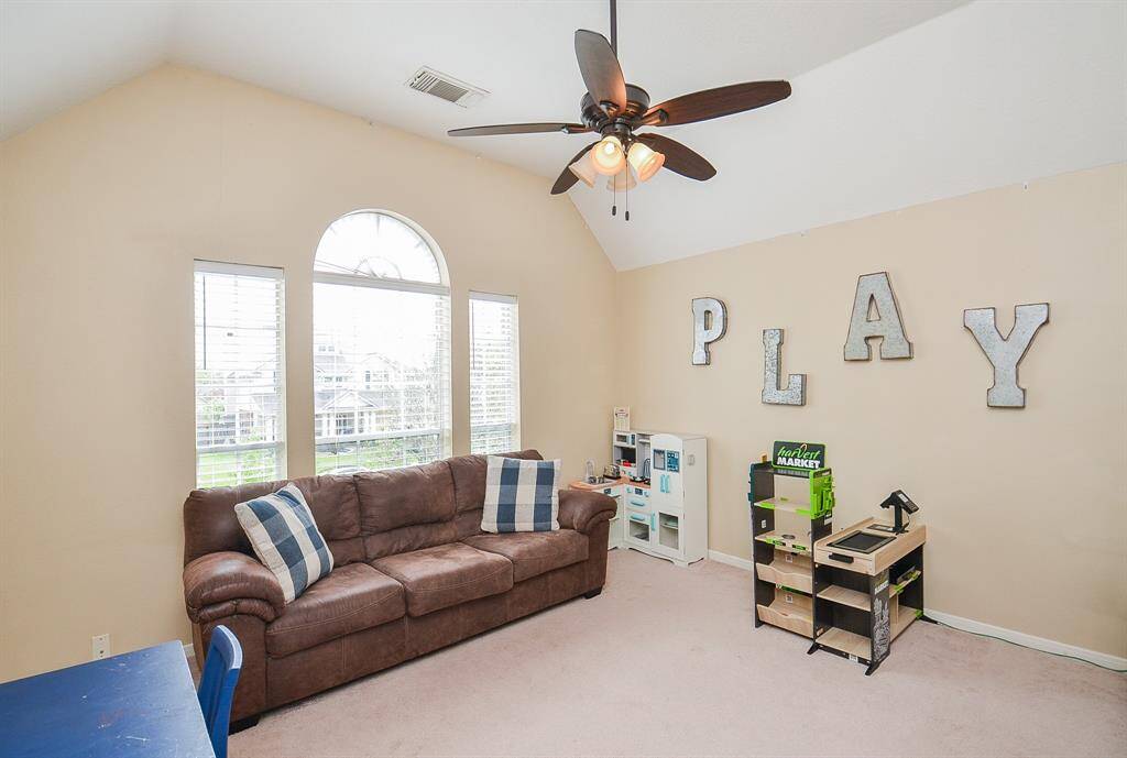 Game room for the kids, or a man cave for the man kid.  Ornate windows with neutral paint and coffered ceiling.