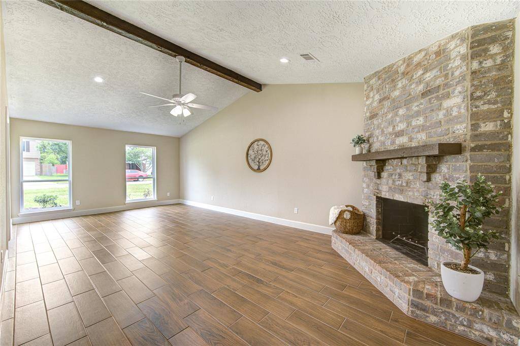 Beautiful living space resting under high ceilings with ample lighting.