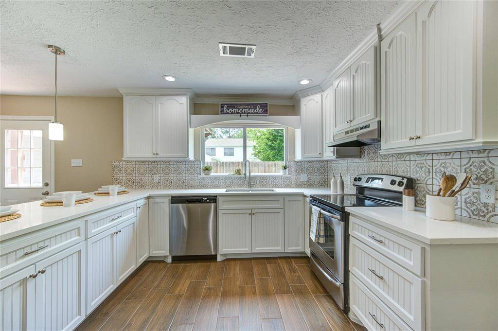 Quartz countertops, custom built cabinets, beautiful backsplash creates stylish elegance.