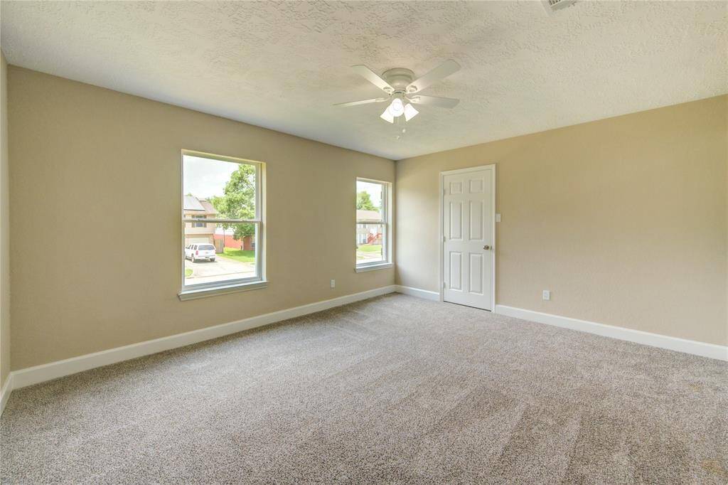 Under high ceilings, you will fall in love with the primary bedroom suite.  It offers plenty of room for a king sized bed as well as plenty of other furniture.