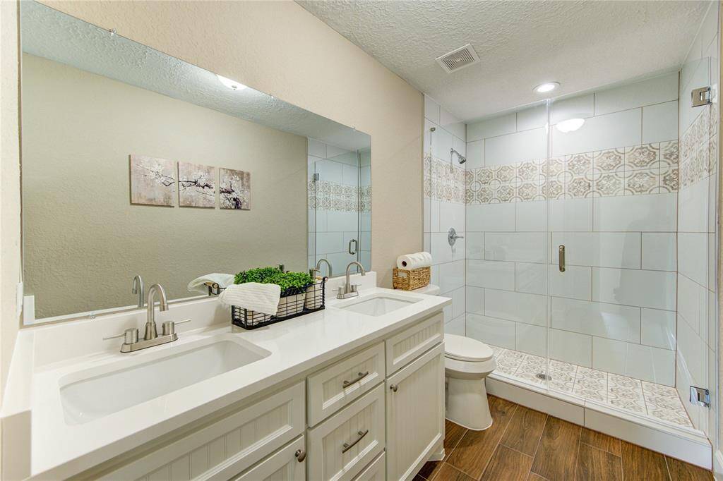 Take a look at the impressive frameless shower that boasts plenty of space and stylish tile design.