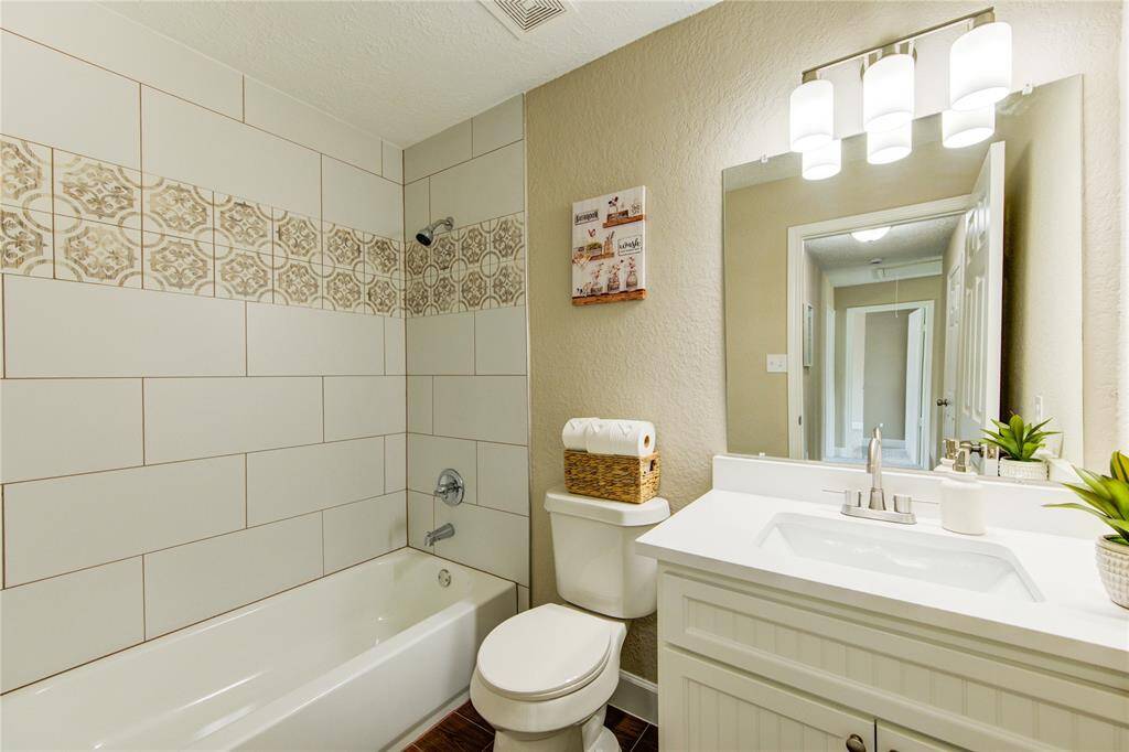Secondary bath with custom built vanity and gorgeous tile work.