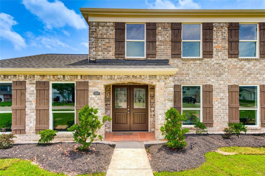 Take a look at the elegant wooden shutters and the welcoming double front door, which together create a warm and inviting exterior.