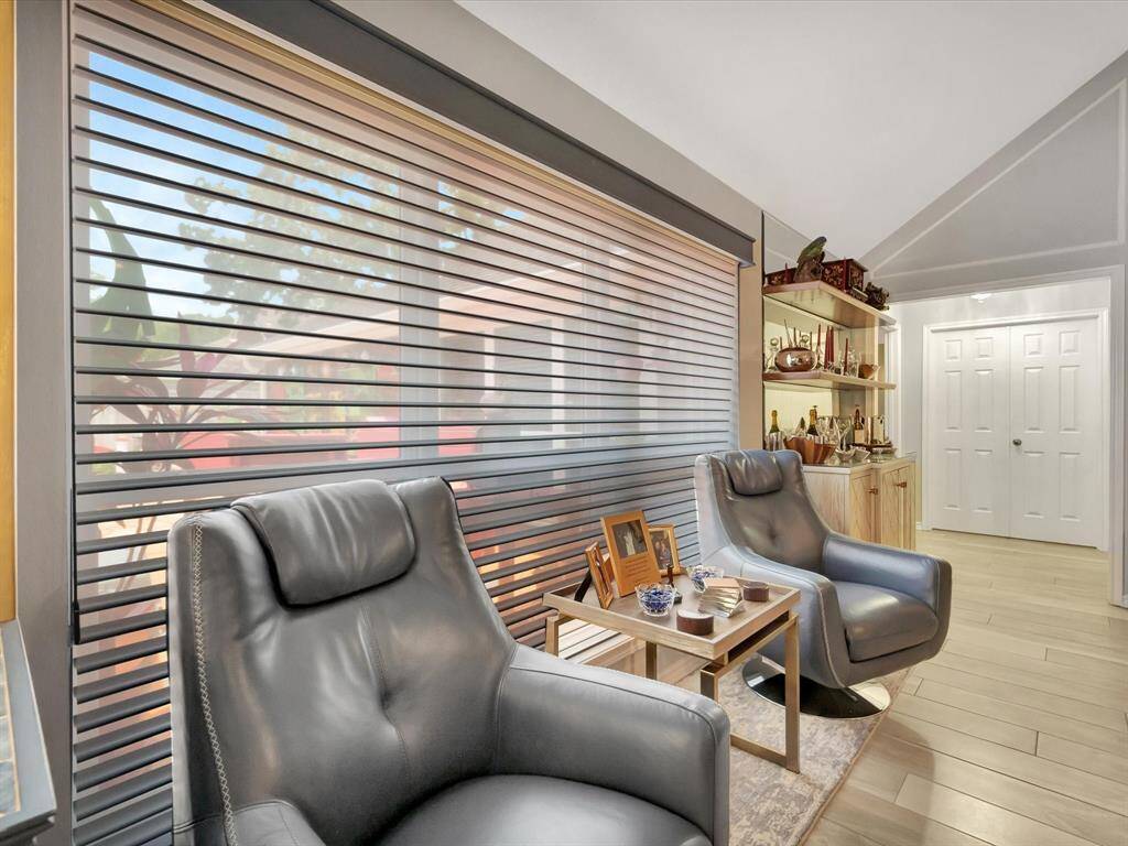 This stylish chill area is perfect for entertaining, featuring two rich mahogany wood shelves backed by a stunning 67" x 58" beveled mirror. The elegant setup creates a sleek bar-inspired atmosphere, reflecting light and adding depth to the space while offering both functionality and visual appeal