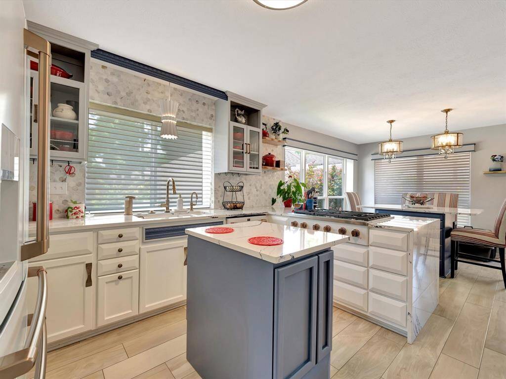 The centerpiece of the kitchen is a sleek PORTABLE island with Cambria quartz countertops, combining modern elegance with everyday functionality. The island thoughtfully conceals trash and recycling bins and tray storage for a clean, streamlined look. Outfitted with high-end GE Café smart appliances, the kitchen blends cutting-edge technology with timeless design—ideal for both cooking and entertaining.