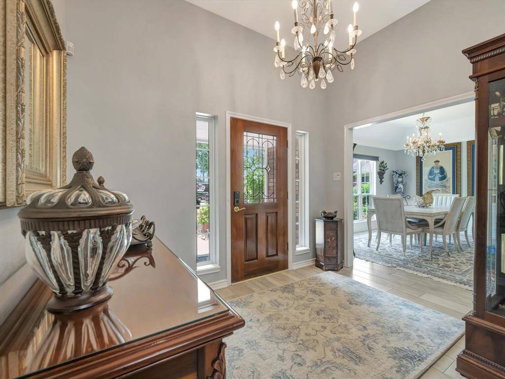 Step into an inviting foyer that offers immediate views of the elegant dining area and spacious living room, creating a warm and open welcome. As an added bonus, the modern front door features a built-in lock camera for enhanced security and peace of mind.