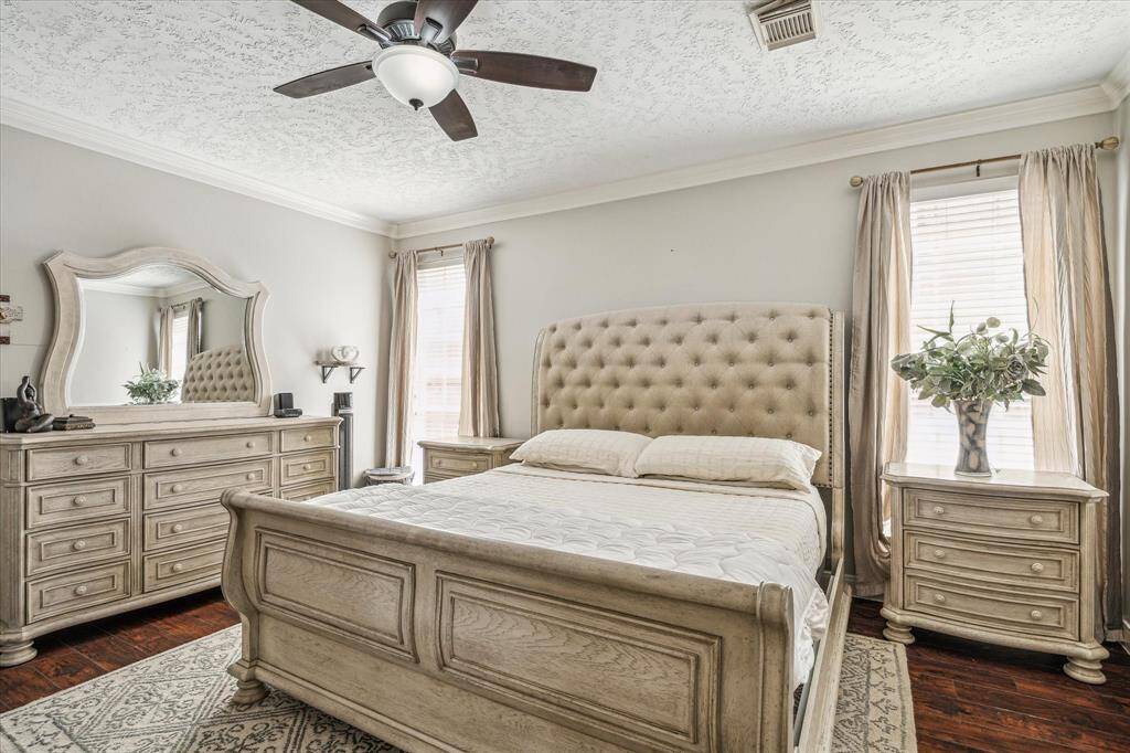 Primary suite located on the first floor, boasting high ceilings for an open and airy feel.