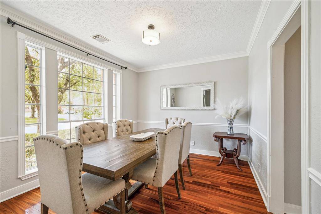 Formal dining room with a large front-facing window that fills the space with beautiful natural light.