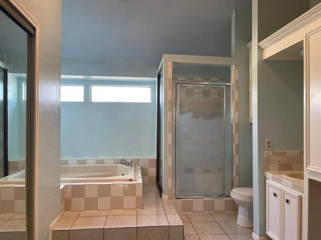 Primary bathroom with separate tub and shower and double sink