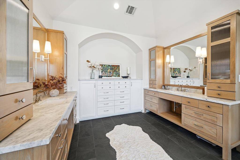 Separate vanities with marble countertops and tons of storage space!