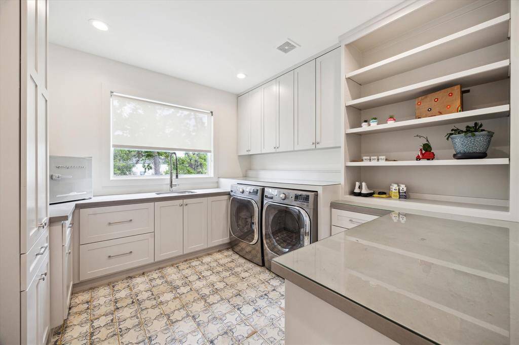 The utility room is functional with lots of countertop space and a sink.