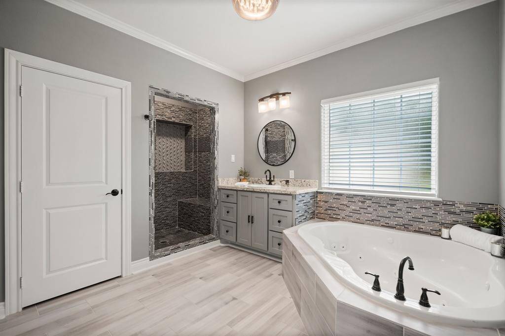 Unwind in the spa-inspired primary bathroom, complete with a soothing jetted tub