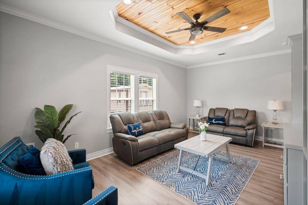 Inviting living room features a beautiful wood-inlay tray ceiling