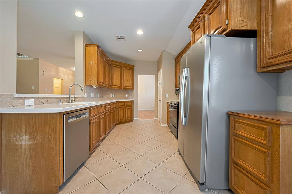 Beautiful gourmet kitchen that is open to all main areas of the home. There is no shortage of cabinet space for storage in this kitchen.