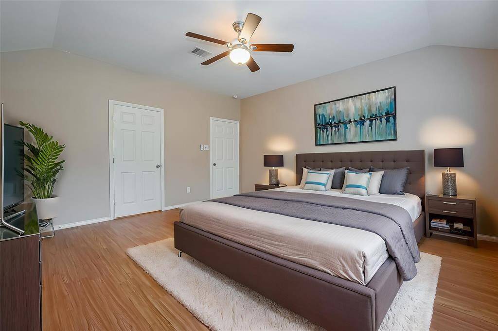 Now we enter the royal primary suite with beautiful bright flooring and space to fit a king size bed.