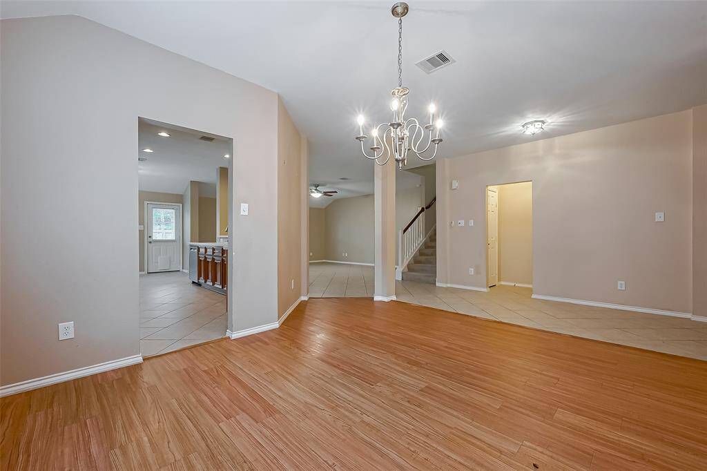 This elongated view amplifies the richness of the formal family and dining areas. Modern light fixtures have been added to give you clean sight lines.