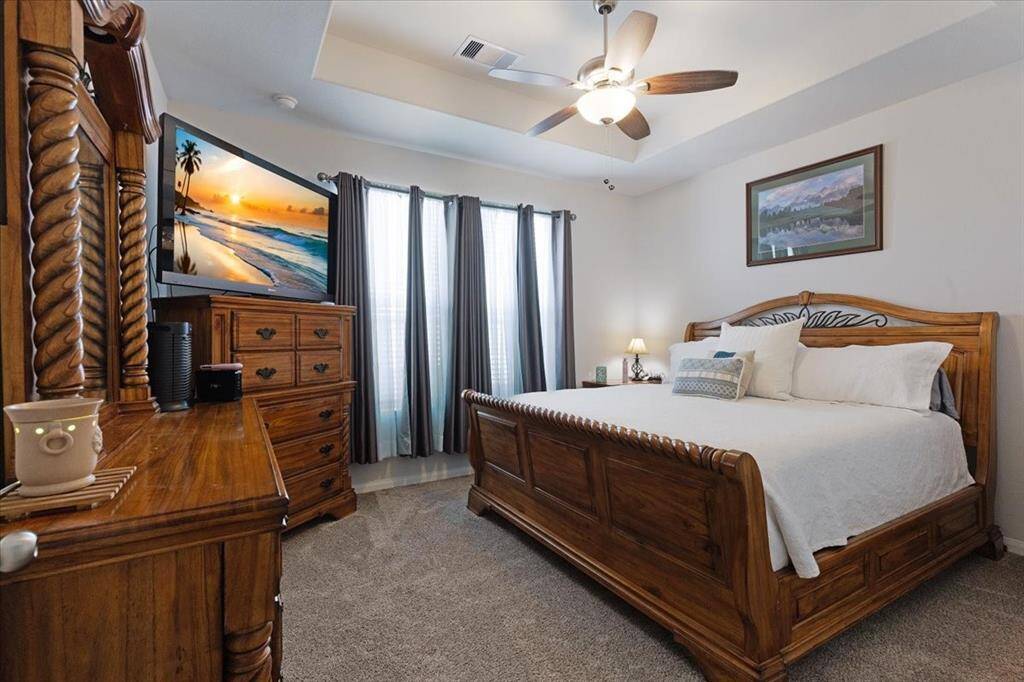 Retreat to your spacious primary suite, featuring elegant tray ceilings that add depth and a touch of luxury.
