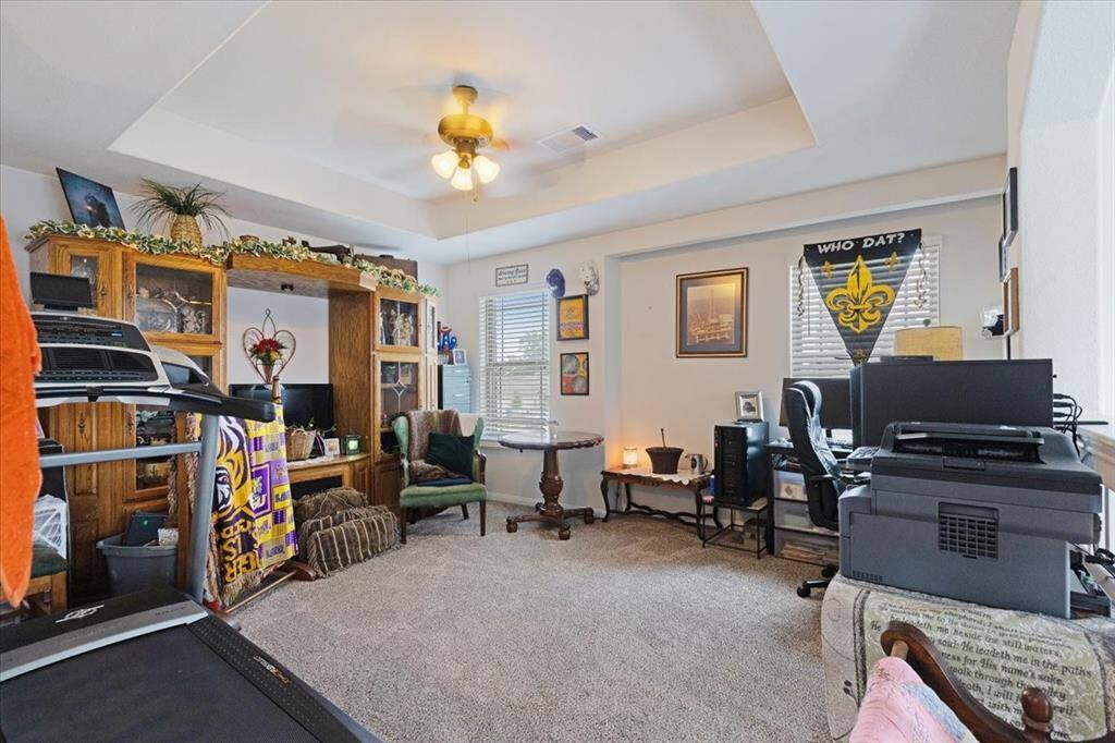 Versatile upstairs game room with elegant tray ceilings. Create your ideal flex space!!