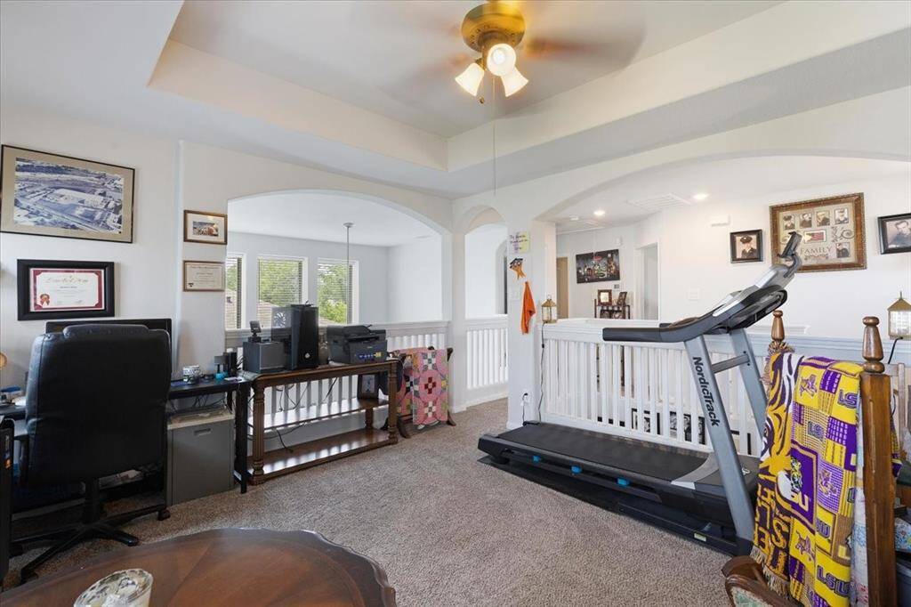 Originally offered as an optional 4th bedroom when built, this spacious upstairs game room with tray ceilings offers flexible living to suit your needs