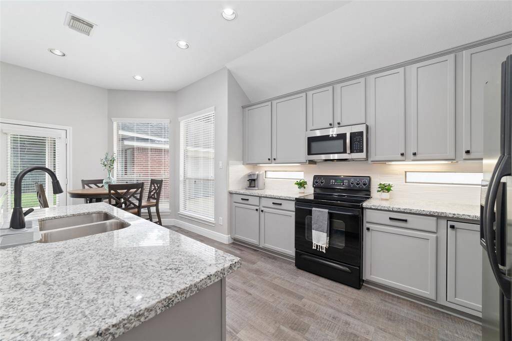 Welcome to your new kitchen at 1706 Maddie Springs Ct. Flooring, countertops, and paint updates.