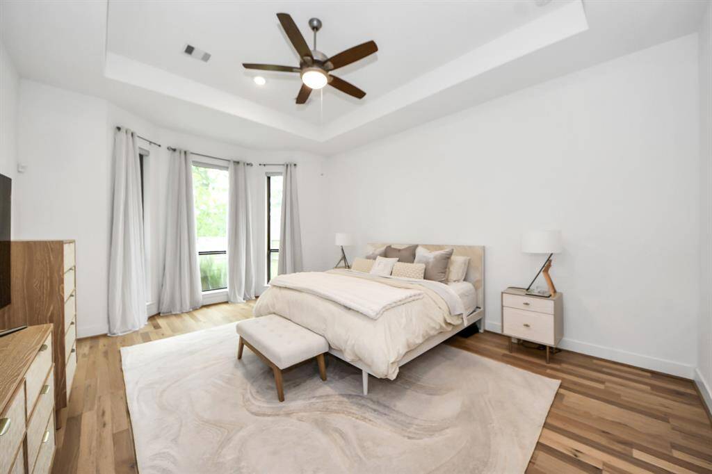 Beautiful and spacious primary suite with plenty of outdoor light controlled by automated zebra blinds.