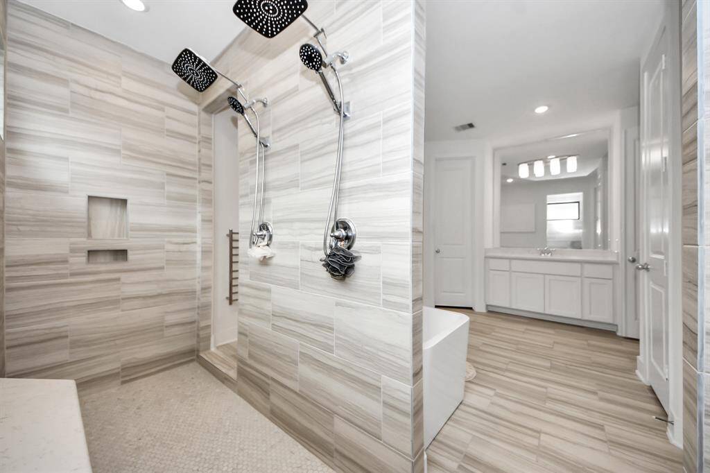 Gorgeous double shower with sitting space and double entry way.