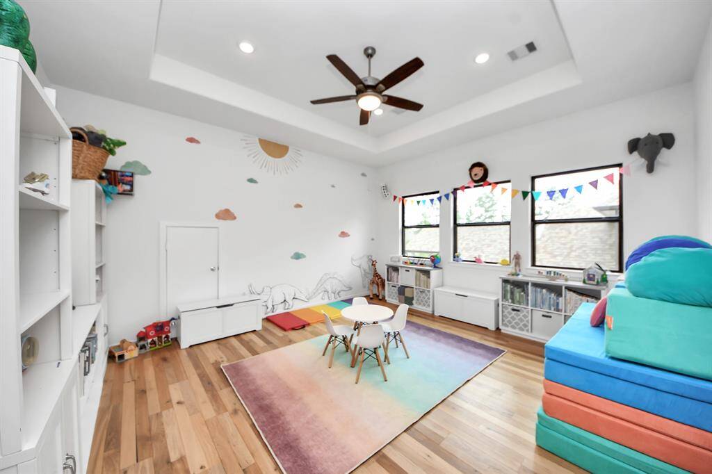 Upstairs gameroom/playroom with an abundance of outdoor light.