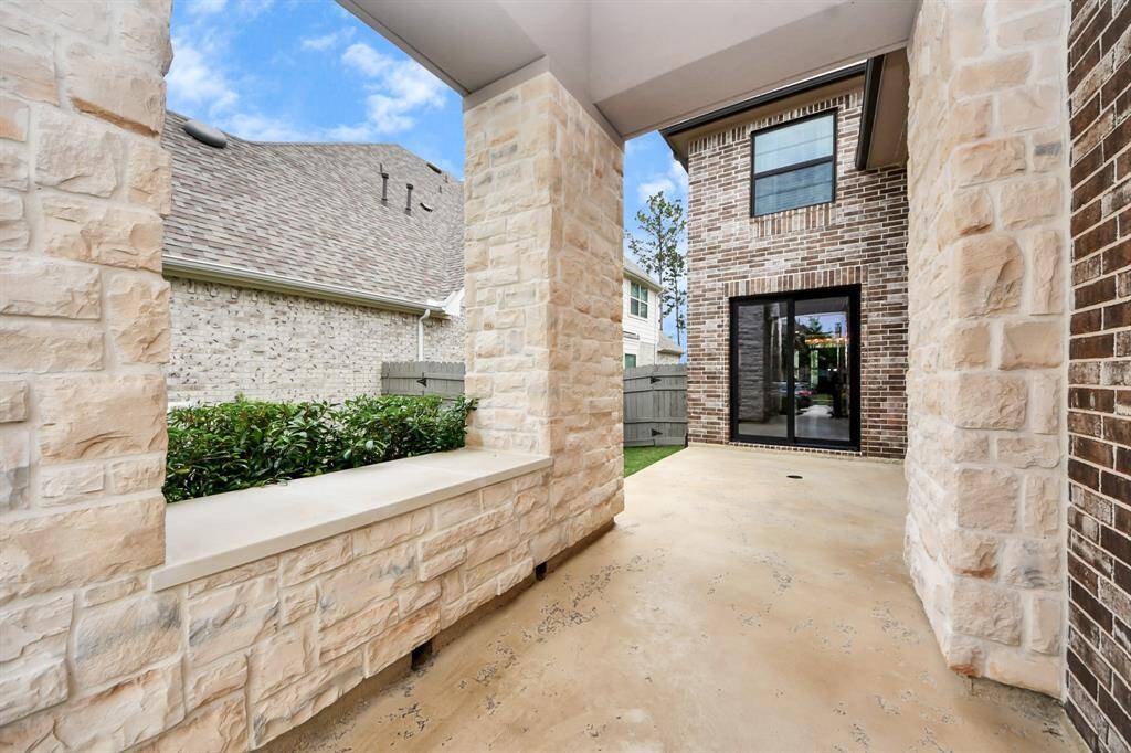 Look at this amazing grand outdoor courtyard granting a view through the sliding glass double doors of the formal dining room. The courtyard is great for entertaining or kids play and is fully enclosable.