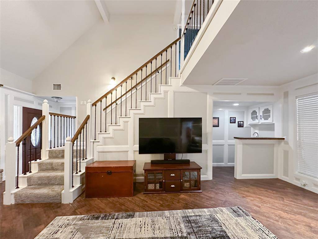 Loft concept invites connection with a view of the recent paint, flooring and updated balusters.