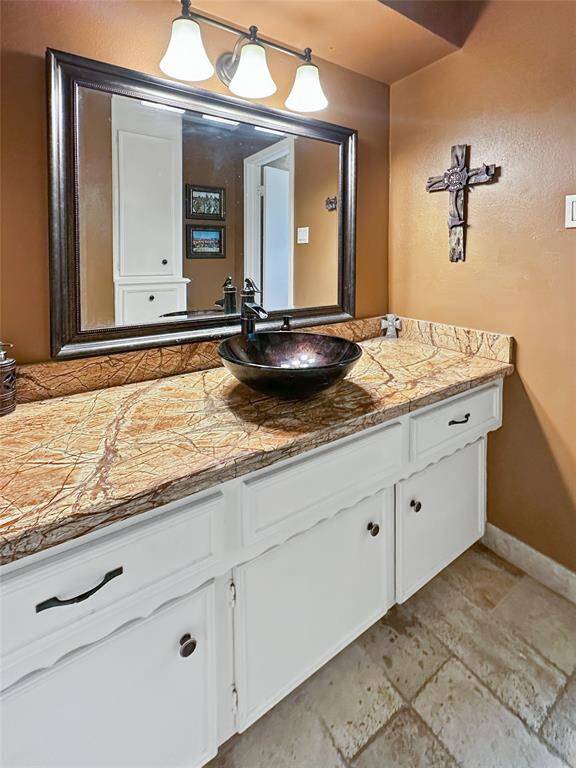 Secondary full restroom conveniently located near the bedrooms and offers updates all around.