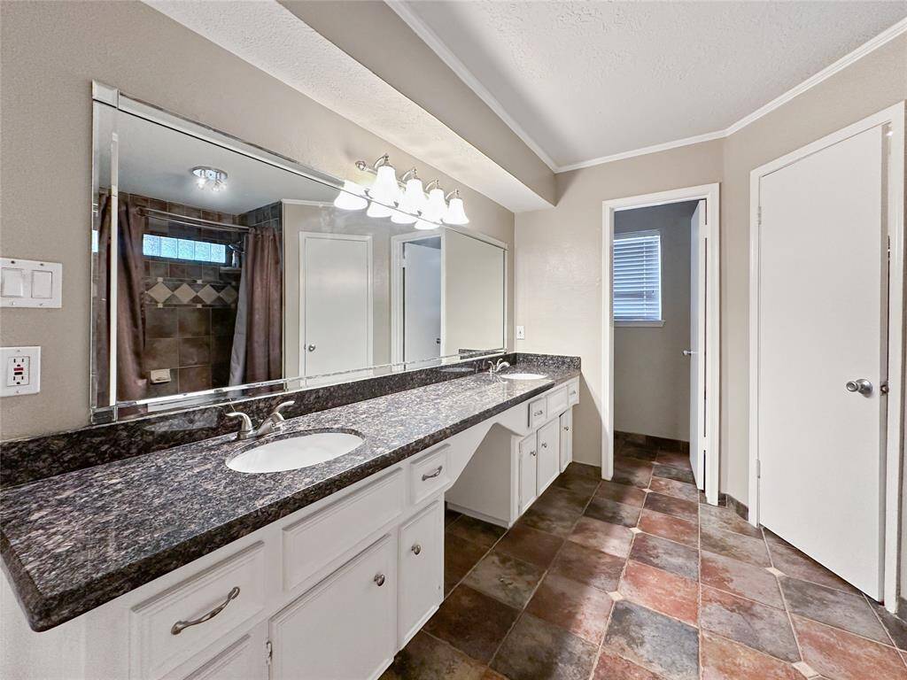 Primary restroom has plenty of storage- includes two walk-in closets!