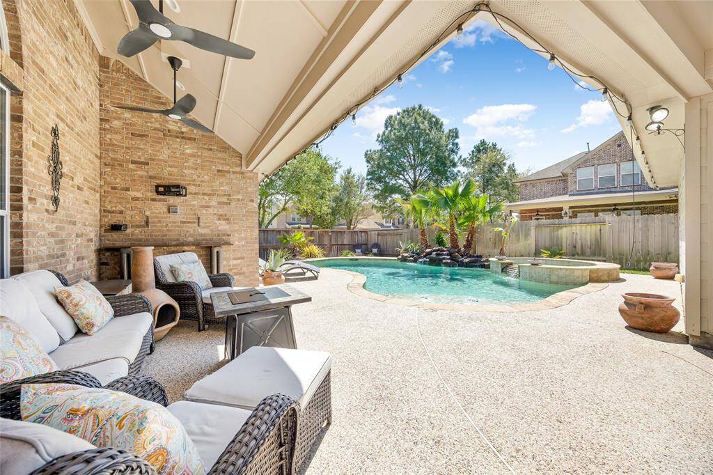 This inviting backyard features an extended covered patio with ceiling fans. Overlooking a beautifully landscape.
