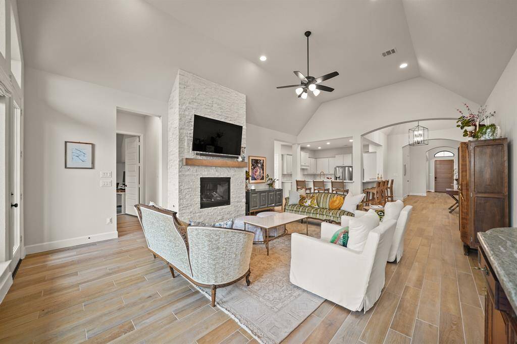 The spacious Family Room seamlessly connects to the Kitchen, offering an open layout that enhances both comfort & functionality for everyday living.