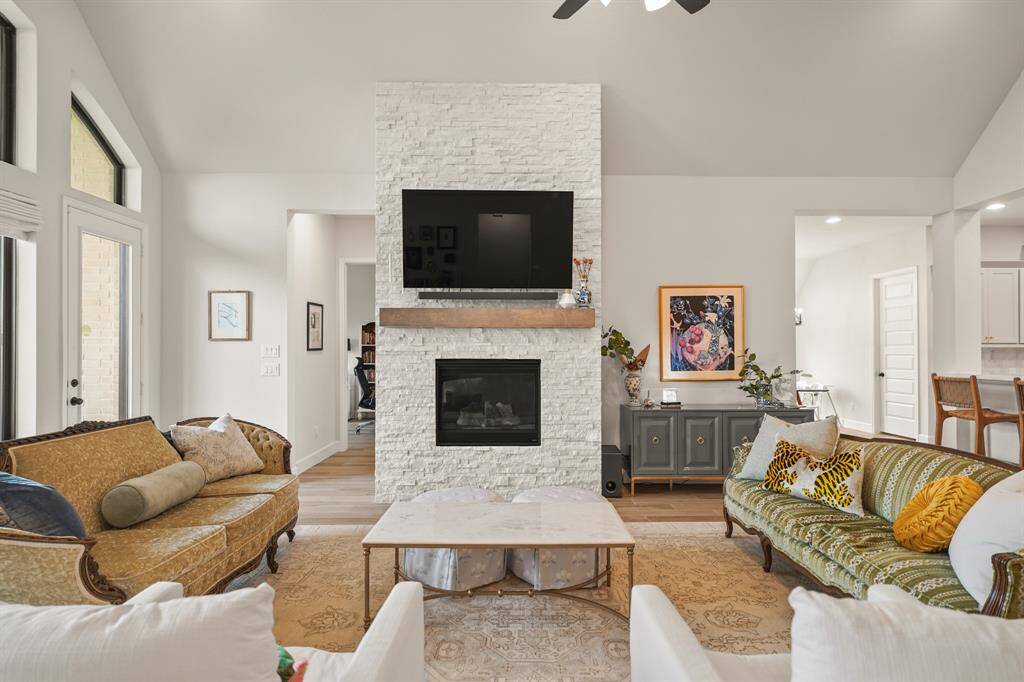 Family Room features a modern Fireplace finished with Crushed Granite & Wood Mantel, adding a beautiful backdrop.