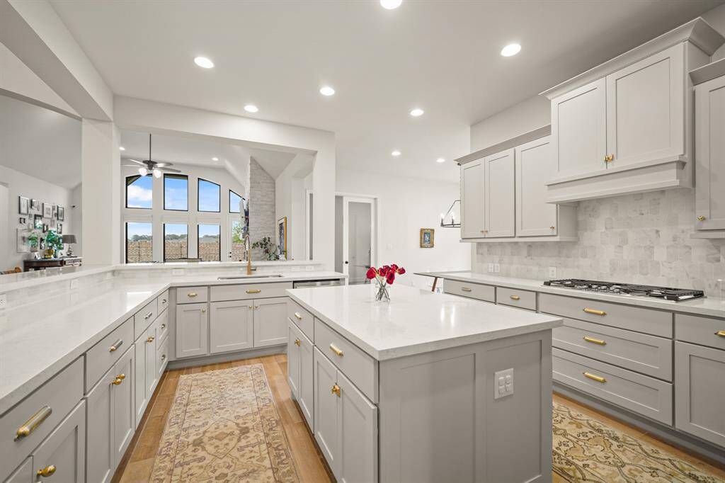 The true chef’s Kitchen offers expansive counter space, a large Quartz island designed to inspire culinary creativity, & seamlessly opens to the Family Room — creating a warm, connected space ideal for entertaining or everyday living.