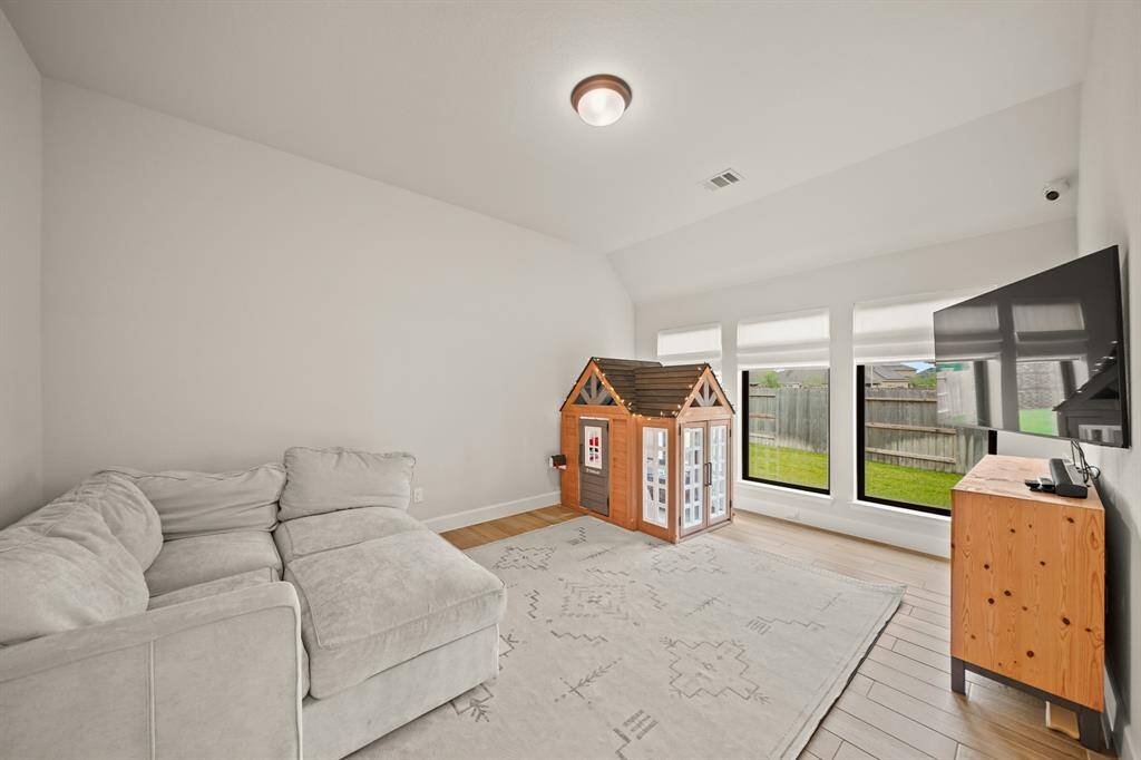 The spacious Game Room offers the perfect setting for movie nights, game tables, or a cozy hangout spot for the whole family.