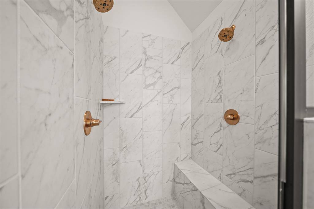 Experience ultimate relaxation in the large tiled shower, featuring two shower heads & a second valve for a fully customizable, spa-like experience.