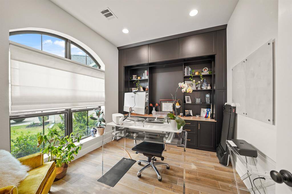 Home Office features lovely custom built-ins, & expansive windows that overlook the charming front yard, creating an inspiring & serene workspace.